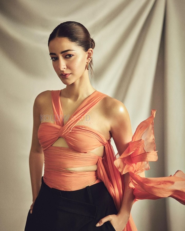 Actress Ananya Panday in a Coral Silk Chiffon Choli Top and Black Crepe Crossover Pants Photos 05