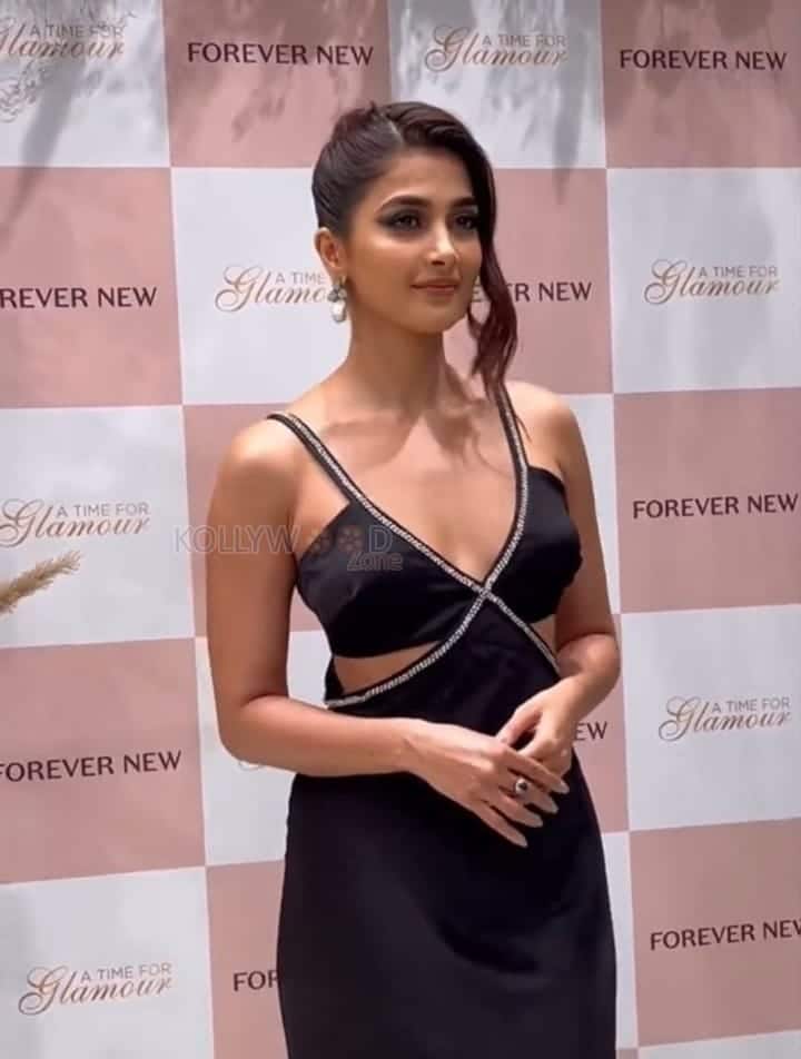 Actress Pooja Hegde in a Black Criss Cross Midi Dress Photos 01