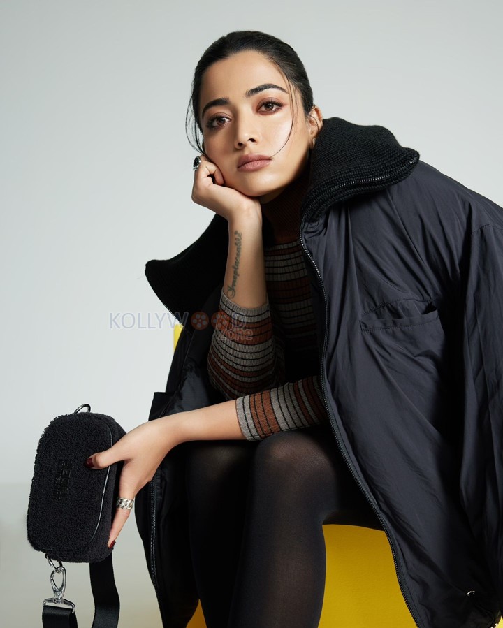 Adorable Actress Rashmika Mandanna in an Oversized Black Puff Jacket with Chic Top and Skirt with Black Leggings Photos 02