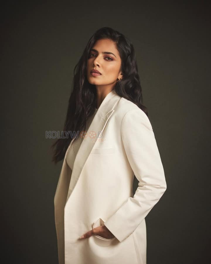 Beautiful Malavika Mohanan in an Off White Bralette with a See Through Top and Trench Coat with White Pants Photos 02