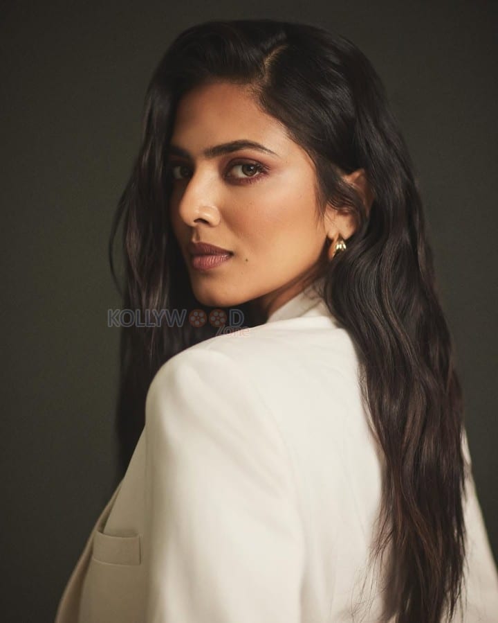 Beautiful Malavika Mohanan in an Off White Bralette with a See Through Top and Trench Coat with White Pants Photos 03