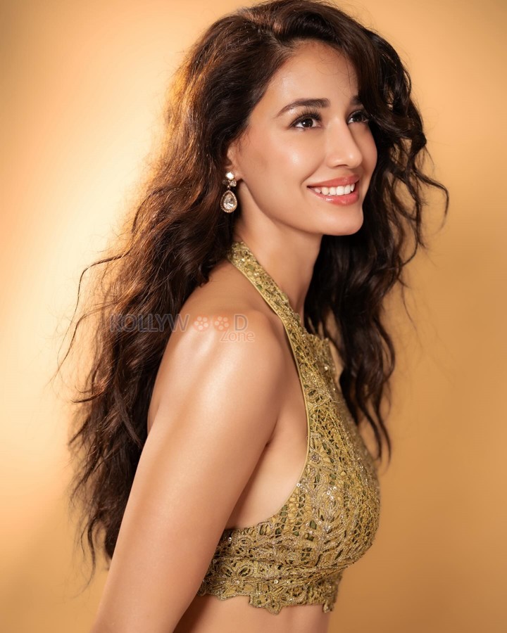 Disha Patani in a Backless Olive Green Pre Draped Skirt with a Halter Neckline Bralette and Dupatta Photos 07