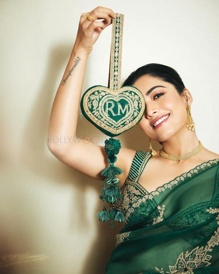 Elegant Rashmika Mandanna in an Emerald Green Saree with Sleeveless Blouse and Heart Shaped Bag Photos 03