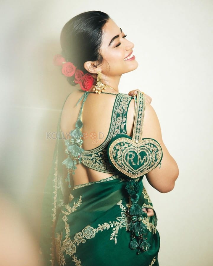 Elegant Rashmika Mandanna in an Emerald Green Saree with Sleeveless Blouse and Heart Shaped Bag Photos 04