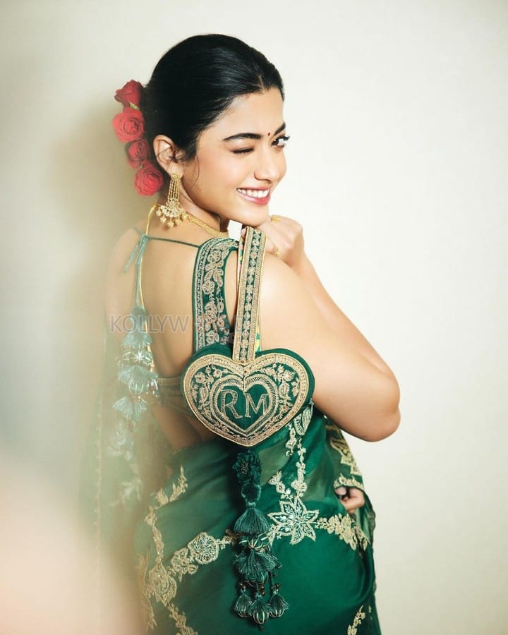 Elegant Rashmika Mandanna in an Emerald Green Saree with Sleeveless Blouse and Heart Shaped Bag Photos 06