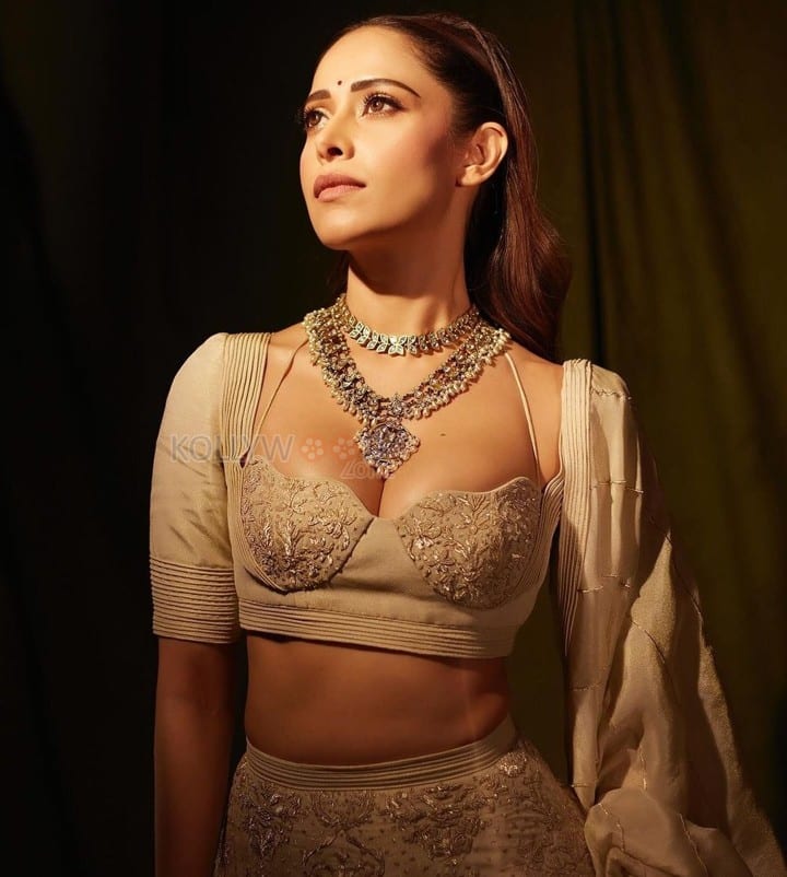 Sizzling Nushrratt Bharuccha in a Beige Lehenga with a Plunging Neckline Blouse Photos 02