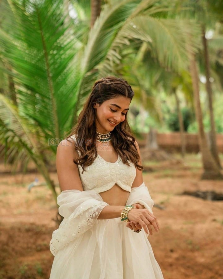 Stunning Actress Pooja Hegde in a White Bridesmaid Lehenga Photos 03