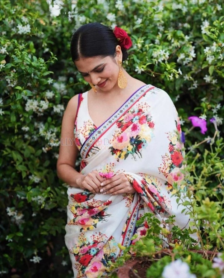 Stunning Beauty Malavika Mohanan in a White Floral Monochromatic Saree with Sleeveless Blouse Photos 02