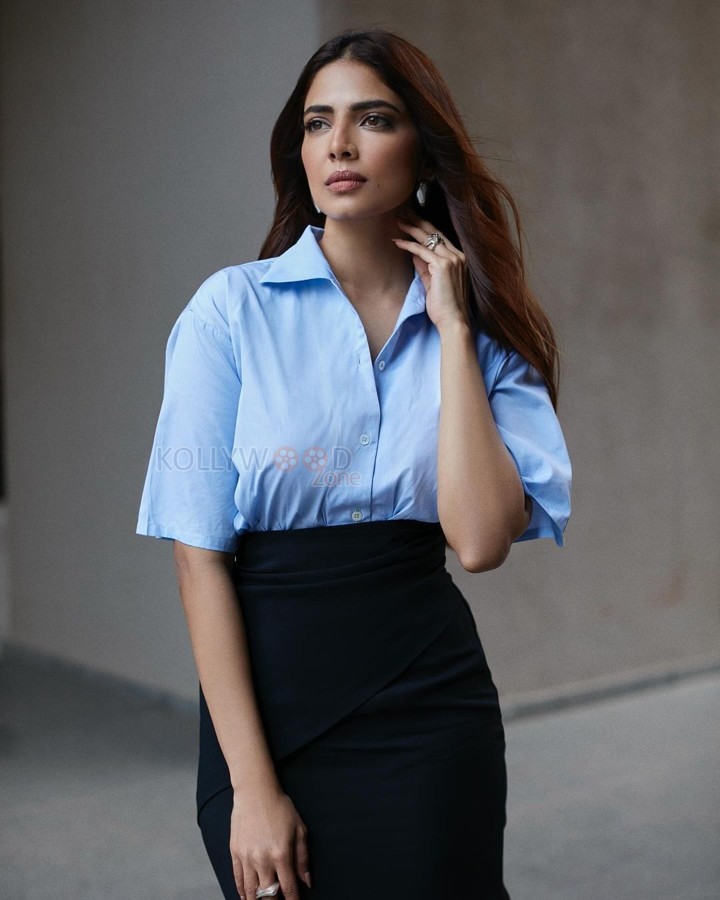 Stylish Malavika Mohanan in a Black Pencil Skirt and Sky Blue Shirt Photos 01