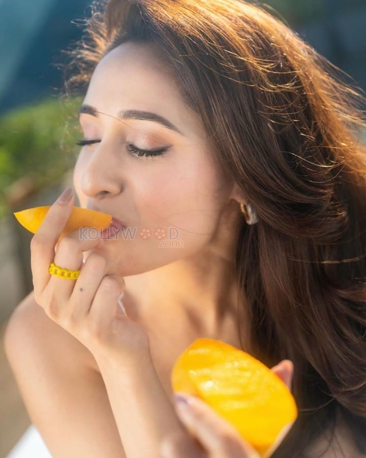 Cute Pragya Jaiswal eating Mangoes in a White Crop Top Photos 03