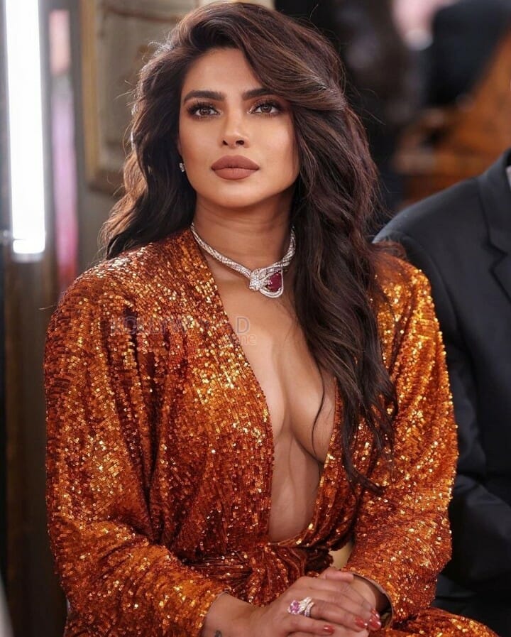 Priyanka Chopra showing Cleavage in an Orange Shimmer Dress Photos 02