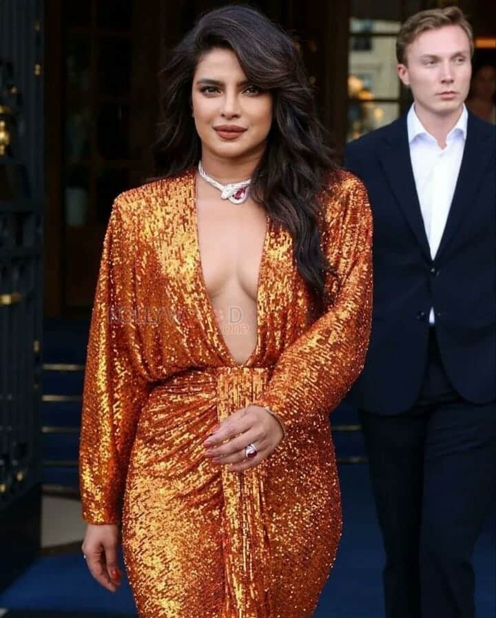 Priyanka Chopra showing Cleavage in an Orange Shimmer Dress Photos 04