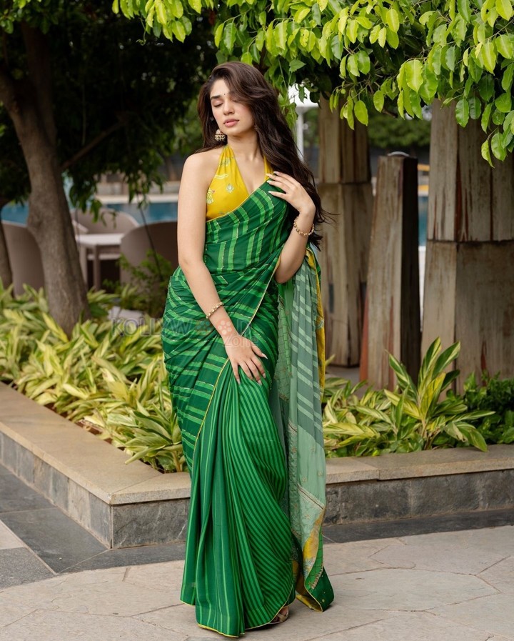 Love Insurance Kompany Actress Krithi Shetty in a Green Saree with a Yellow Halter Neck Blouse Pictures 05