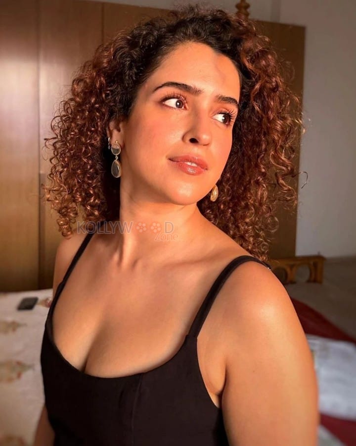 Actress Sanya Malhotra in a Black Spaghetti Strap Top and Curly Hair Photos 01