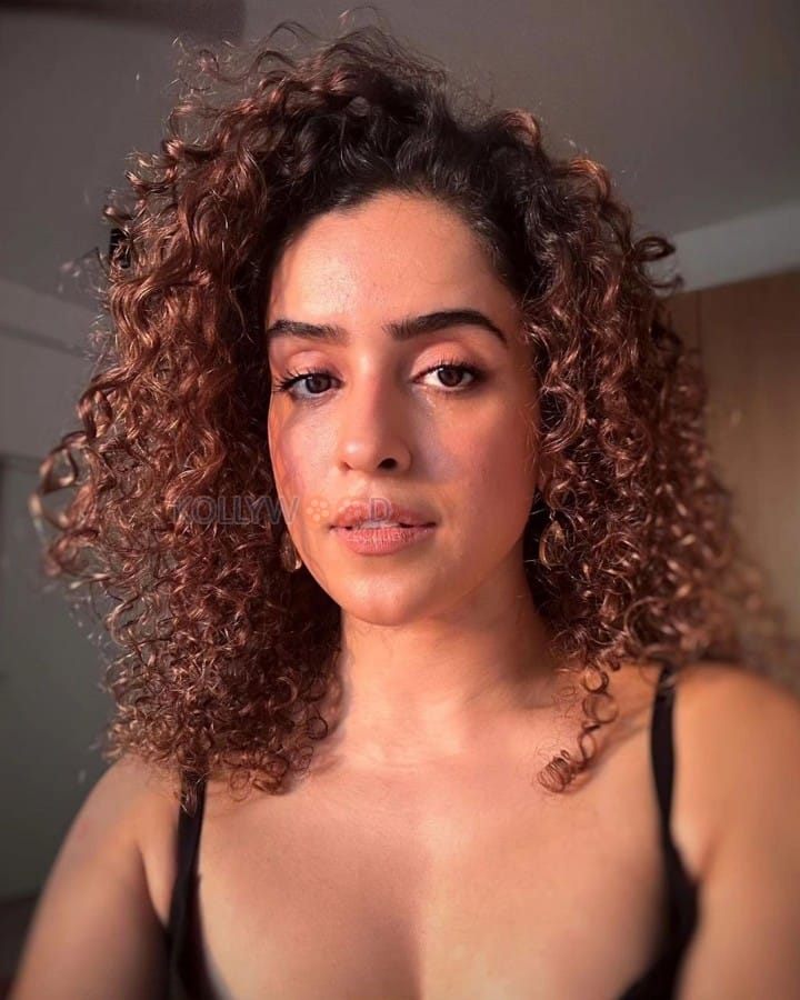 Actress Sanya Malhotra in a Black Spaghetti Strap Top and Curly Hair Photos 02