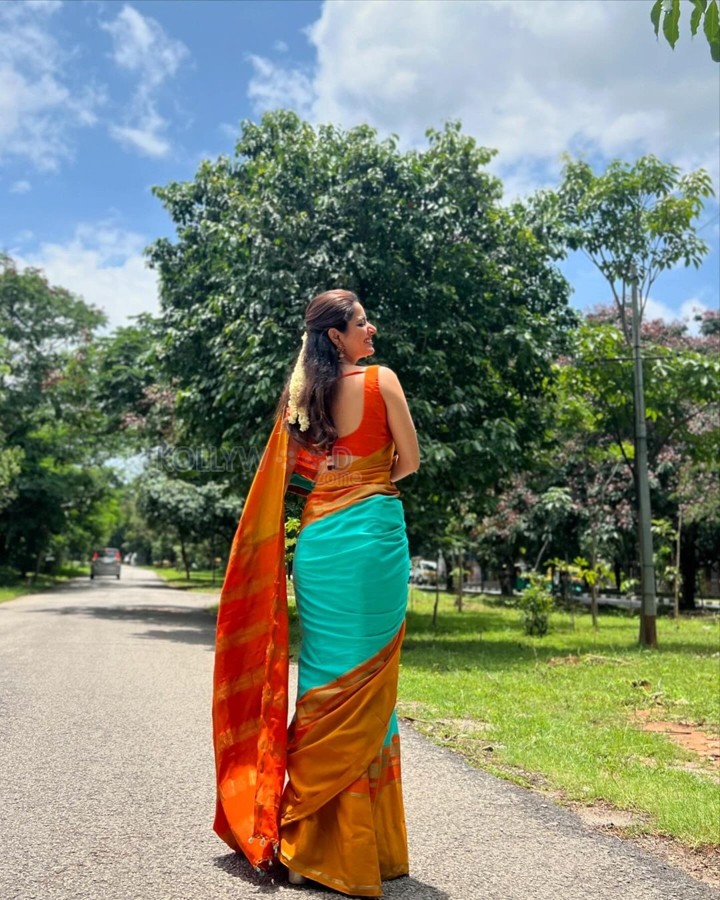 Beautiful Ashika Ranganath in a Vibrant Orange Saree with a Sleeveless Blouse Photos 01