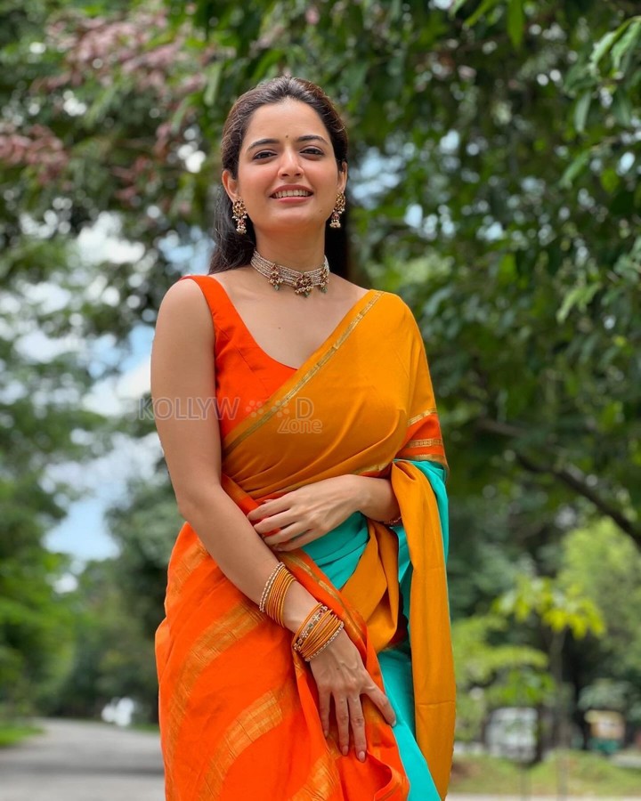 Beautiful Ashika Ranganath in a Vibrant Orange Saree with a Sleeveless Blouse Photos 05