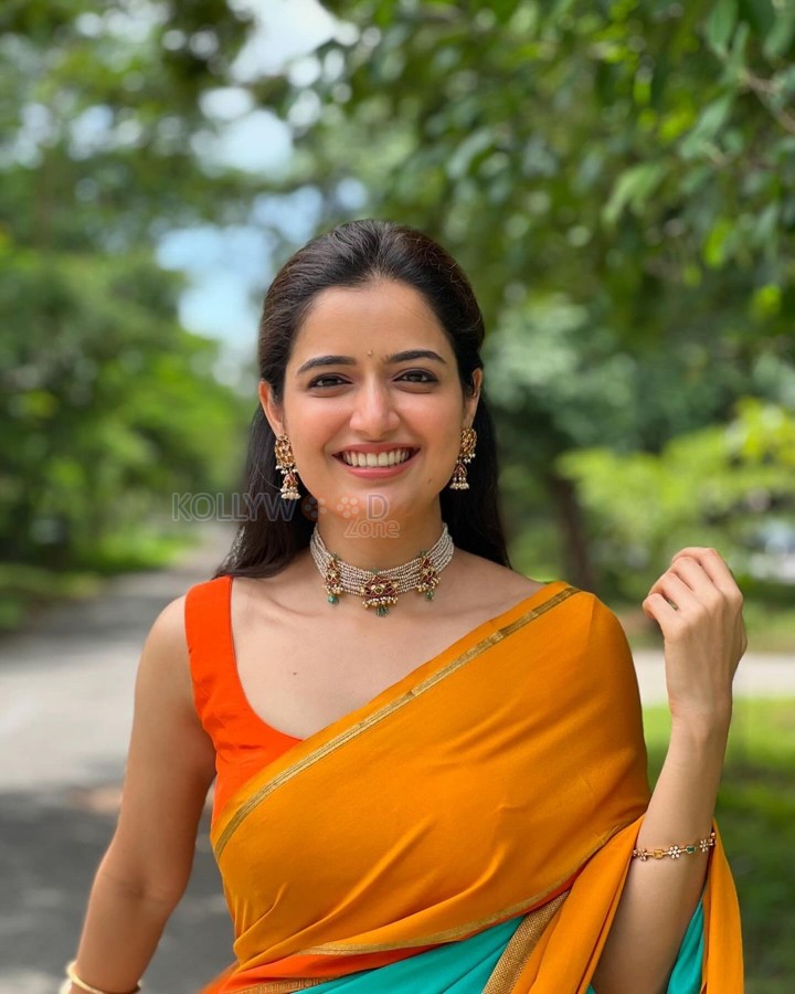 Beautiful Ashika Ranganath in a Vibrant Orange Saree with a Sleeveless Blouse Photos 06