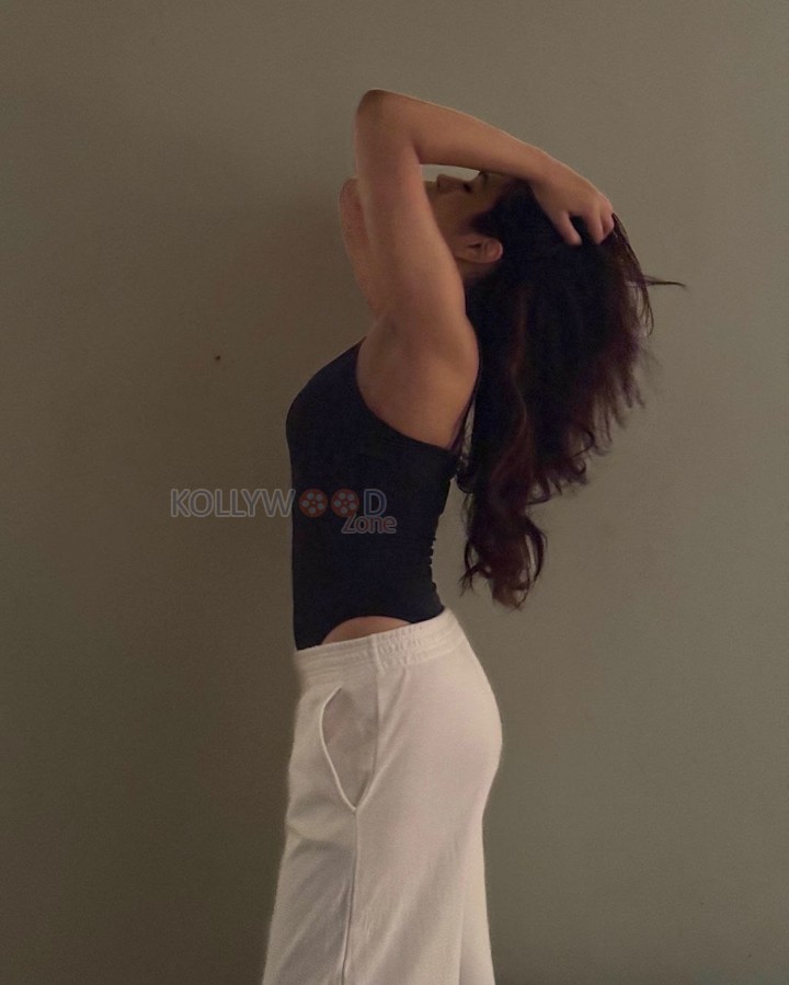 Stunning Shraddha Das in a Sleeveless Black Top and White Pants Photos 02