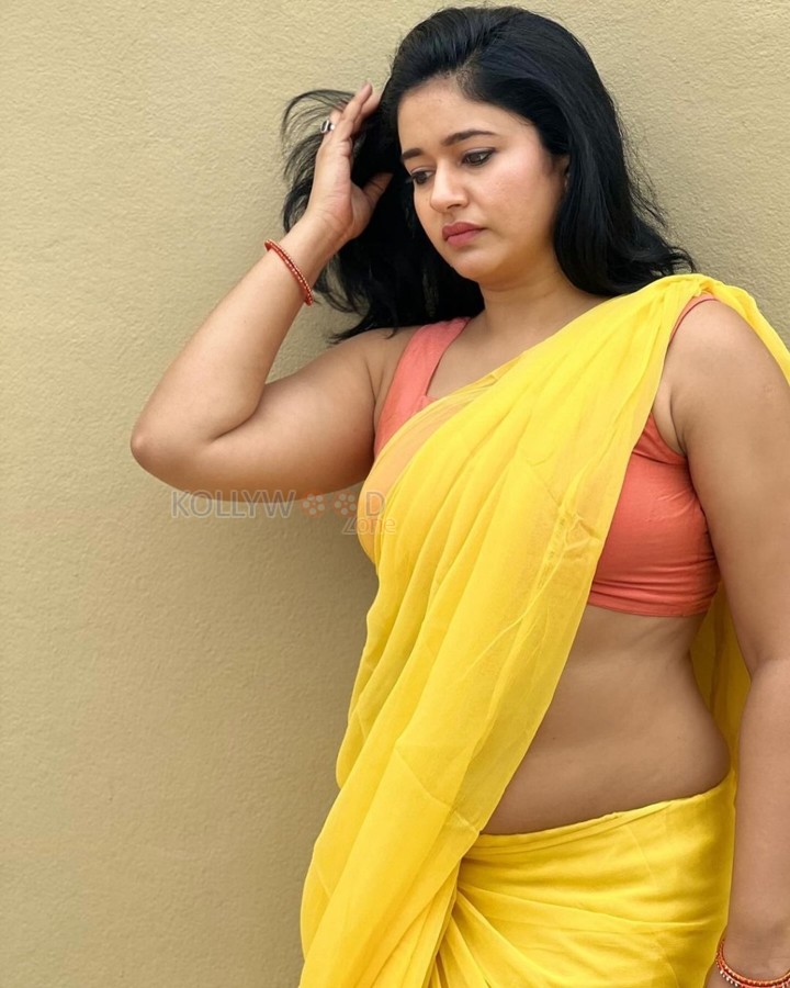 Mesmerizing Poonam Bajwa in a Yellow Saree with Sleeveless Orange Blouse Photos 07