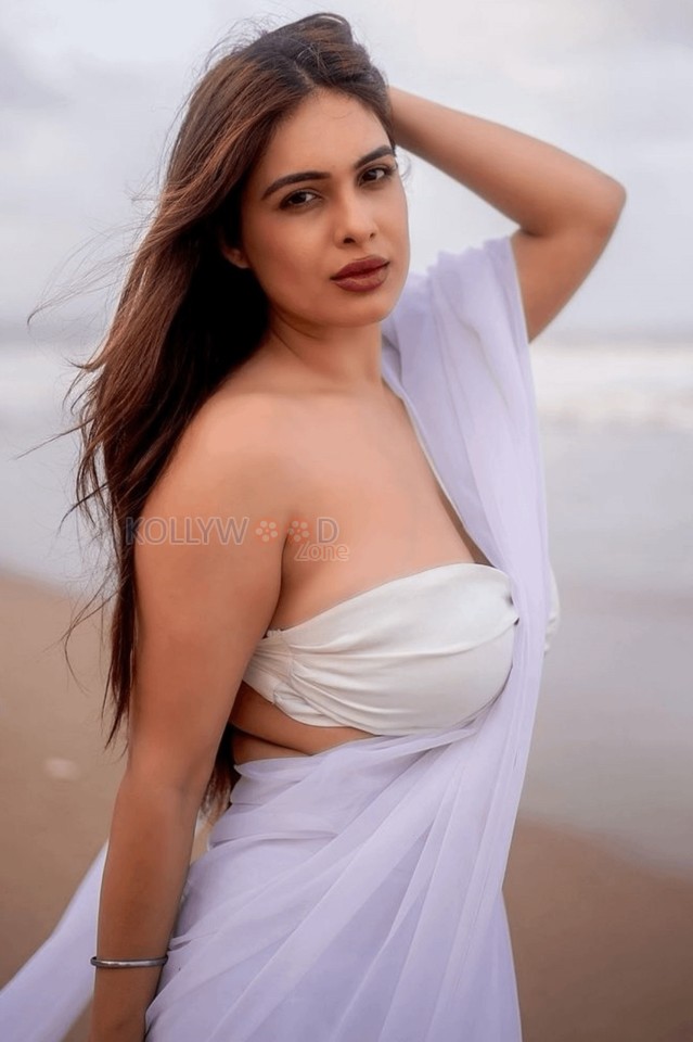 Bold Neha Malik in a White Saree with Sleeveless Blouse on the Beach Photos 01