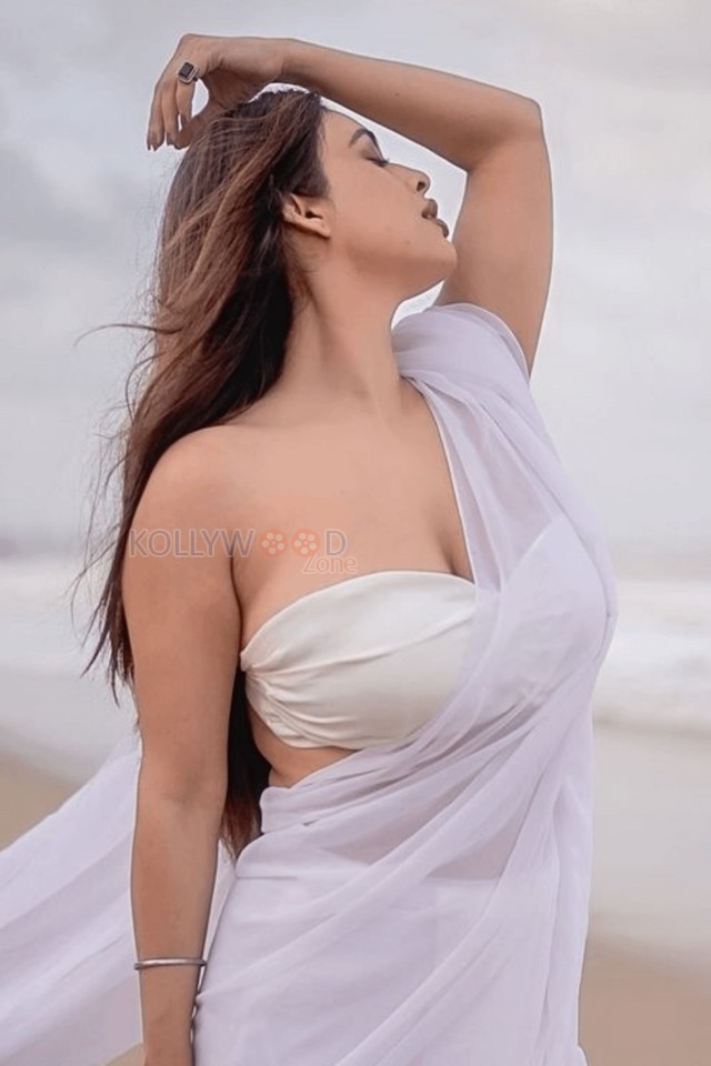 Bold Neha Malik in a White Saree with Sleeveless Blouse on the Beach Photos 03