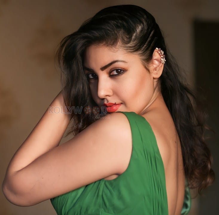 Beautiful Komal Jha in a Green V Neck Dress Photos 02