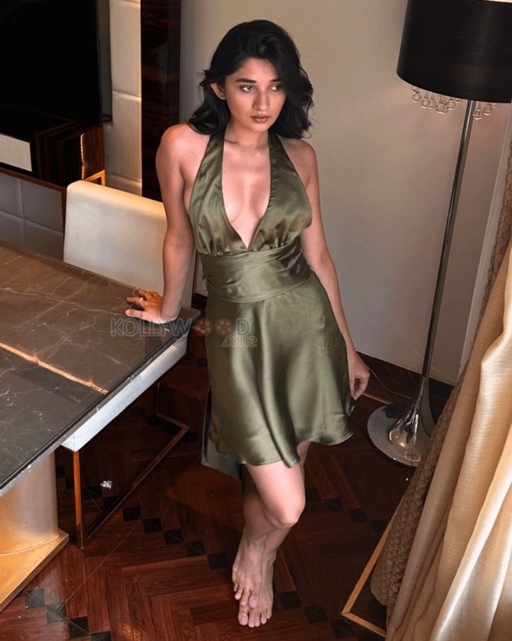 Seductive Kanika Mann in a Moss Green Halterneck Deep Neck Back Knot Dress Photos 02