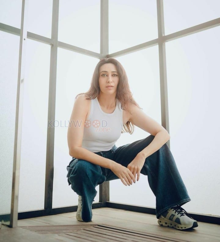 Actress Karisma Kapoor in a Classic Jeans and White Top Photos 01