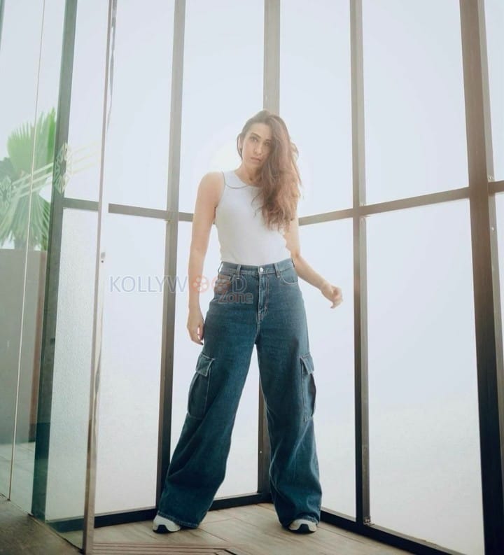 Actress Karisma Kapoor in a Classic Jeans and White Top Photos 02