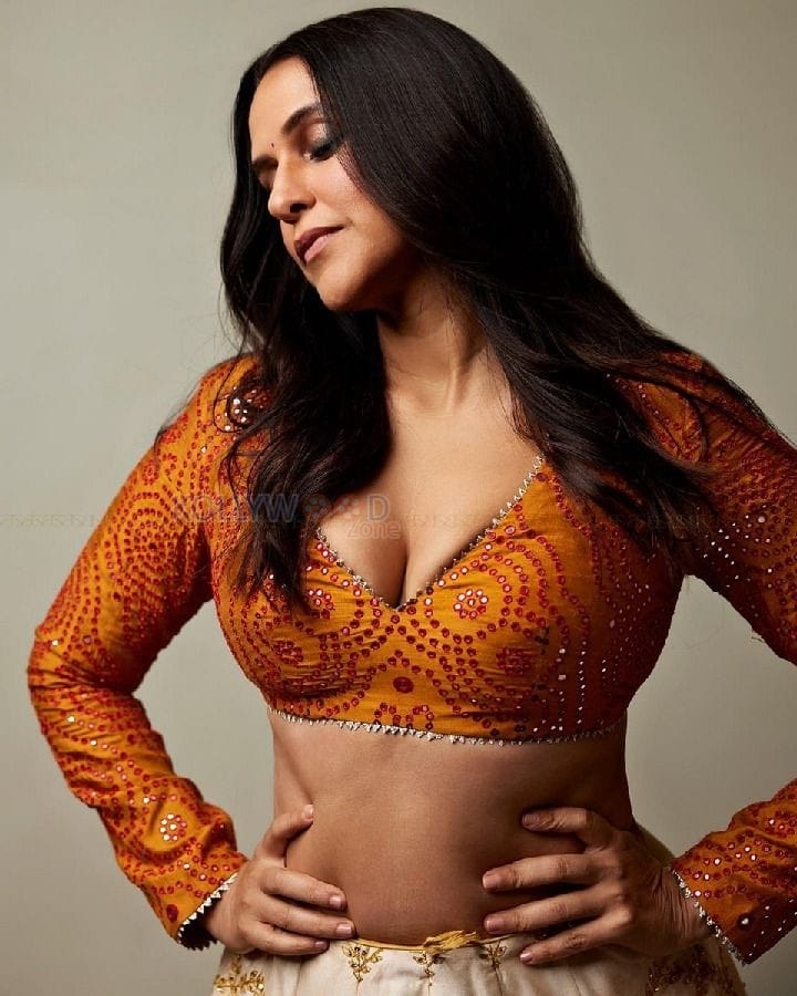 Classy Neha Dhupia in a Radiant Orange Lehenga Photos 01