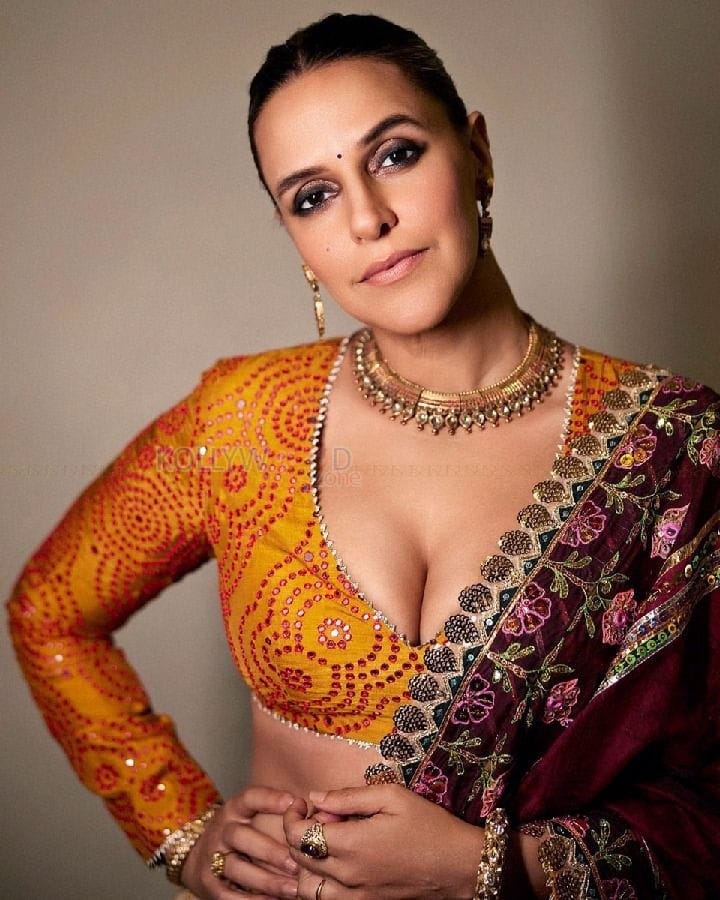 Classy Neha Dhupia in a Radiant Orange Lehenga Photos 02