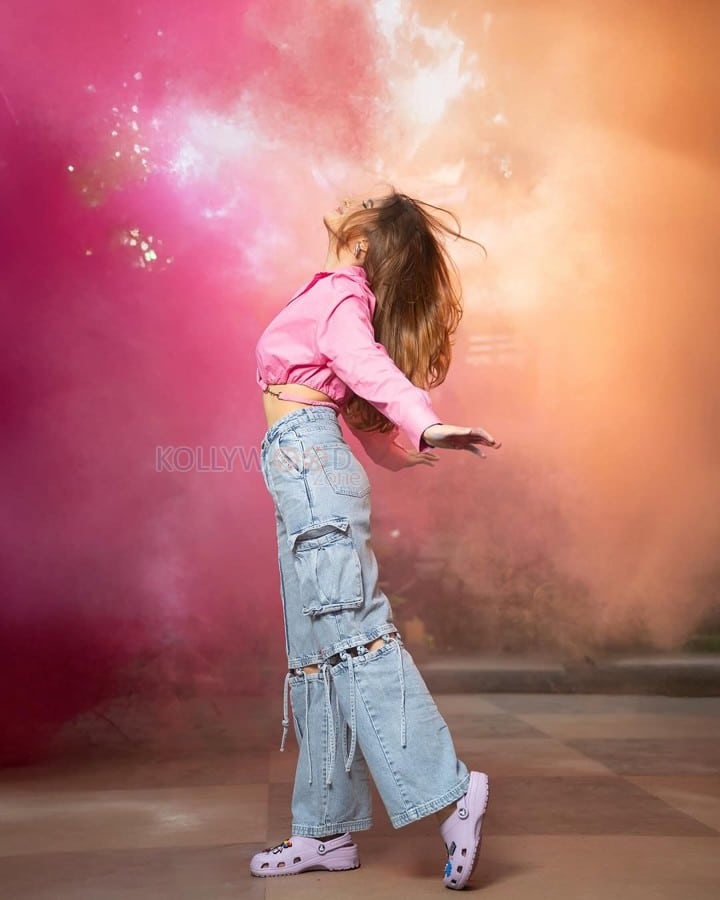 Sexy Rasha Thadani in a Pink Knot Shirt and Torn Denim Pants for Holi Celebration Photos 05