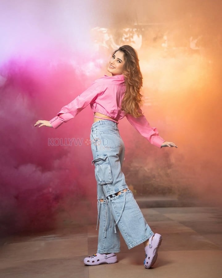 Sexy Rasha Thadani in a Pink Knot Shirt and Torn Denim Pants for Holi Celebration Photos 09