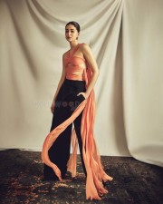 Actress Ananya Panday in a Coral Silk Chiffon Choli Top and Black Crepe Crossover Pants Photos 02