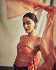 Actress Ananya Panday in a Coral Silk Chiffon Choli Top and Black Crepe Crossover Pants Photos 04