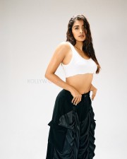 Beautiful Bollywood Actress Pooja Hegde in a White Ribbed Crop Top and Wrinkled Black Cargo Pants Photos 01