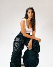 Beautiful Bollywood Actress Pooja Hegde in a White Ribbed Crop Top and Wrinkled Black Cargo Pants Photos 03