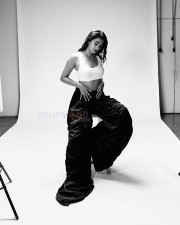 Beautiful Bollywood Actress Pooja Hegde in a White Ribbed Crop Top and Wrinkled Black Cargo Pants Photos 04