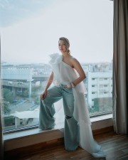 Breathtaking Tamannaah Bhatia in a Ruffled One Shoulder White Top with Ripped Denim Jeans Photos 04