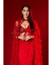 Busty Nora Fatehi in a Red Saree with Cleavage Revealing Neckline Photos 01