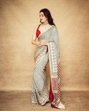 South Actress Kajal Aggarwal in a Red Sleeveless Blouse and Striped Saree Photos 02