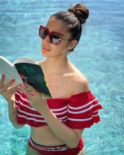 Stunning Raai Laxmi Reading in a Red Swimsuit Photos 01