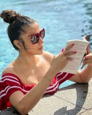 Stunning Raai Laxmi Reading in a Red Swimsuit Photos 03