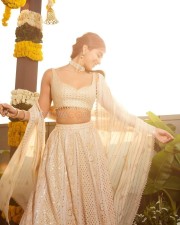 Stylish Pooja Hegde in a Cream Embroidered Lehenga Set Photos 03