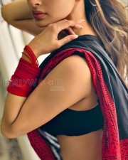 Erotic Mouni Roy Showing Navel in a Black Saree wtih Red Border Photos 03