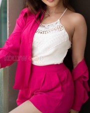 Sexy Iswarya Menon in a Pink Shorts and White Noodle Strap Floral Top Photos 02