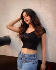 Alluring Nabha Natesh in a Black Crop Top with Blue Denim Shorts Photos 01