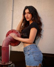 Alluring Nabha Natesh in a Black Crop Top with Blue Denim Shorts Photos 03