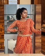 Glamorous Heroine Anupama Parameswaran in an Orange Pre Draped Saree Photos 02